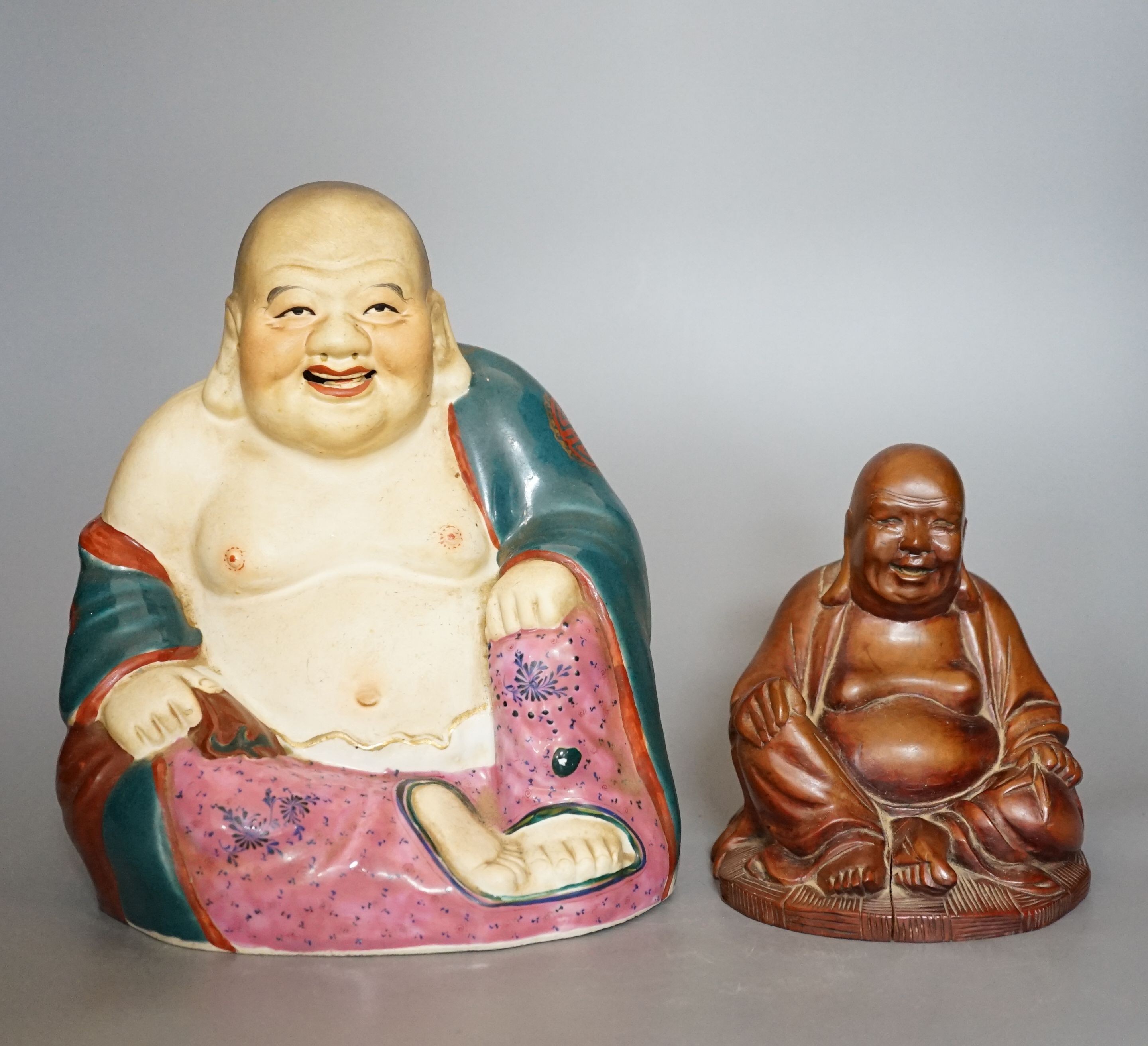 A Chinese enamelled porcelain figure of Budai and a similar carved wood figure (2)